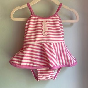 Pink and white stripe one piece swimsuit with seahorse appliqué and bow detail